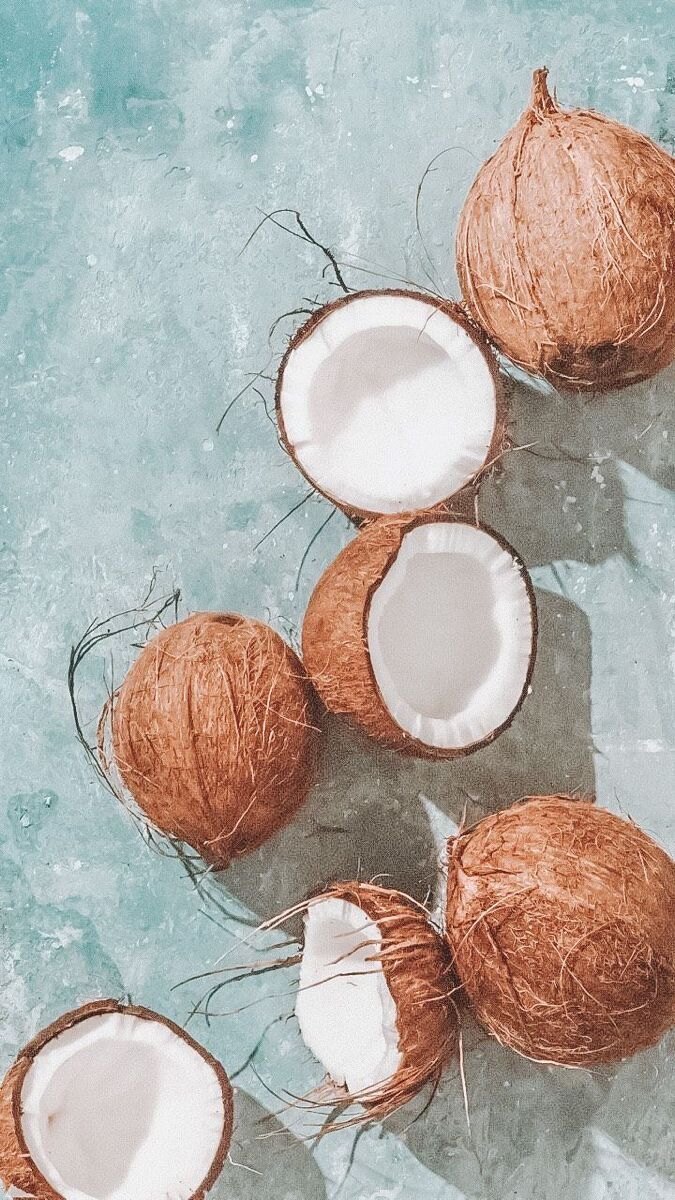Fresh coconuts, whole and halved