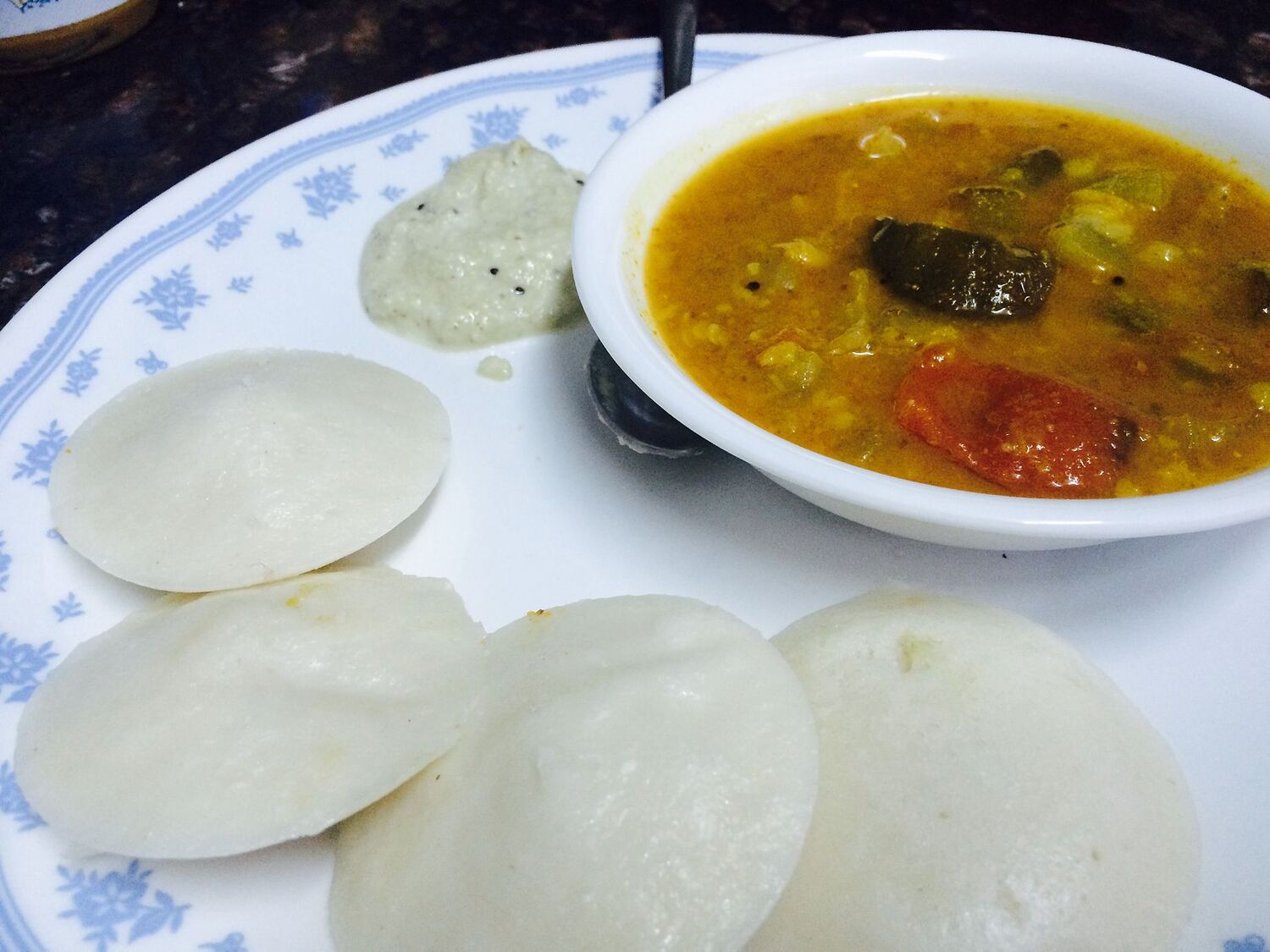 Idli served with sambar and chutney